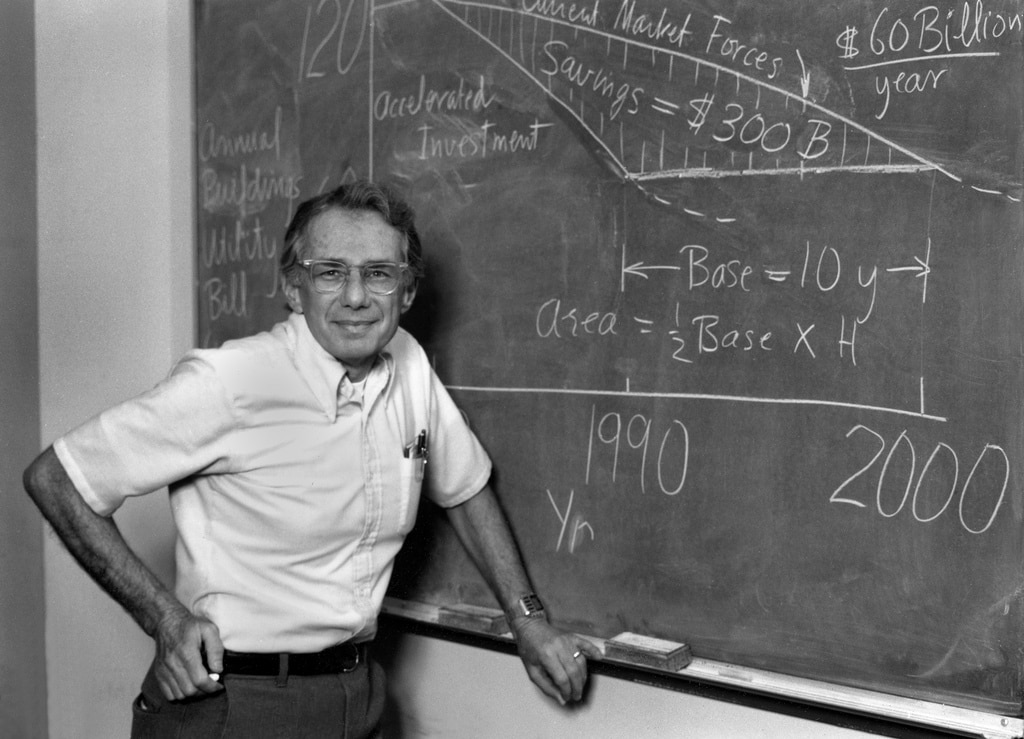 Art Rosenfeld posing in front of a chalkboard covered in math equations