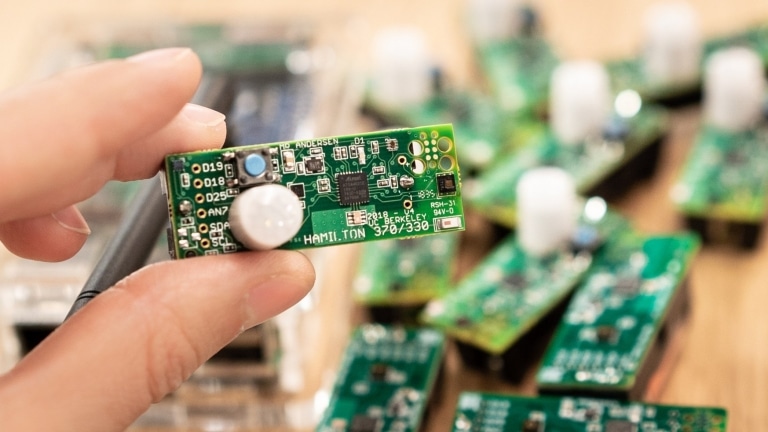 closeup of a hand holding a small computer chip