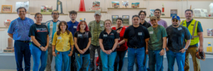 CREL Student Researchers and Faculty standing in a row in a Bakersfield College display room