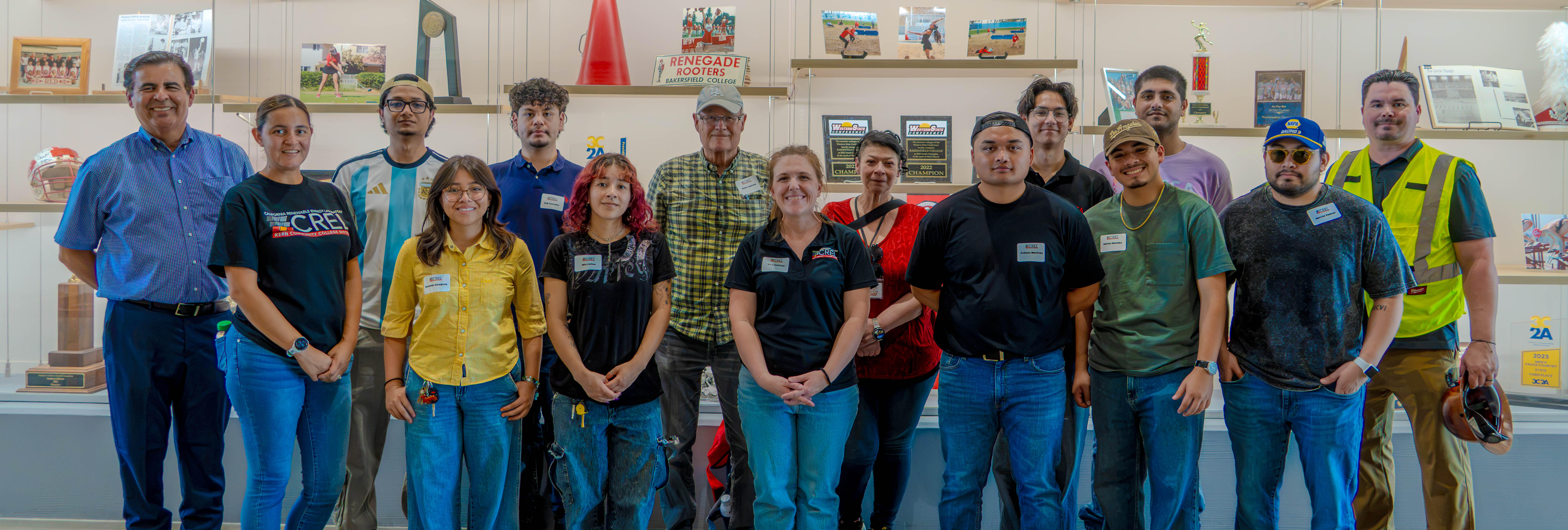 CREL Student Researchers and Faculty standing in a row in a Bakersfield College display room